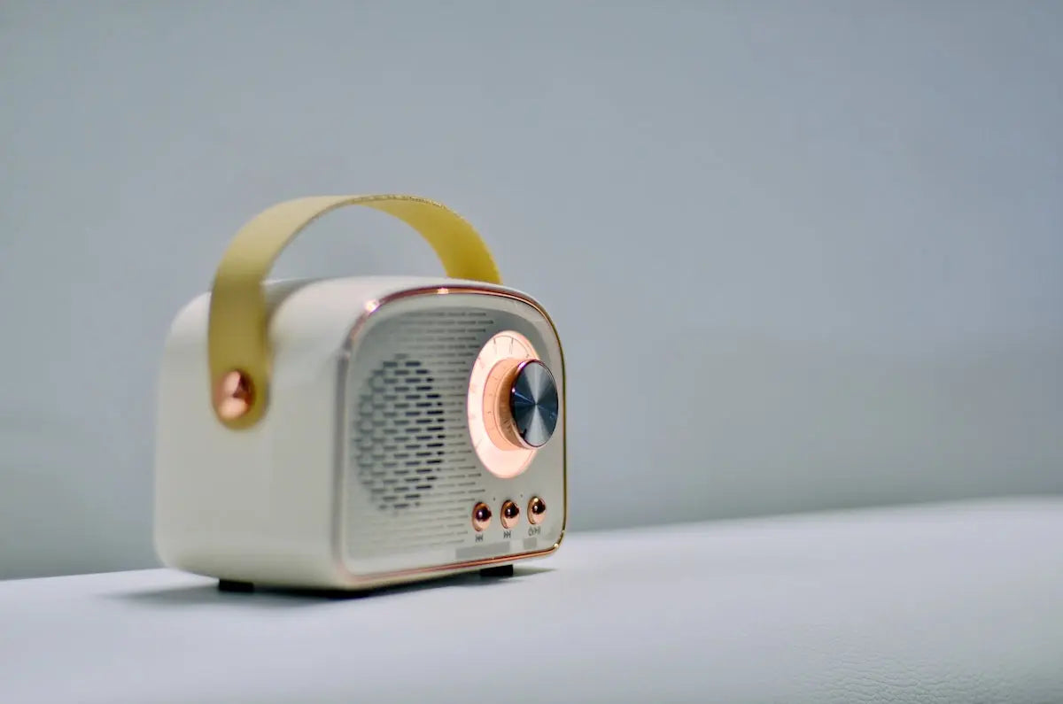 A retro-style radio speaker sits on a table.