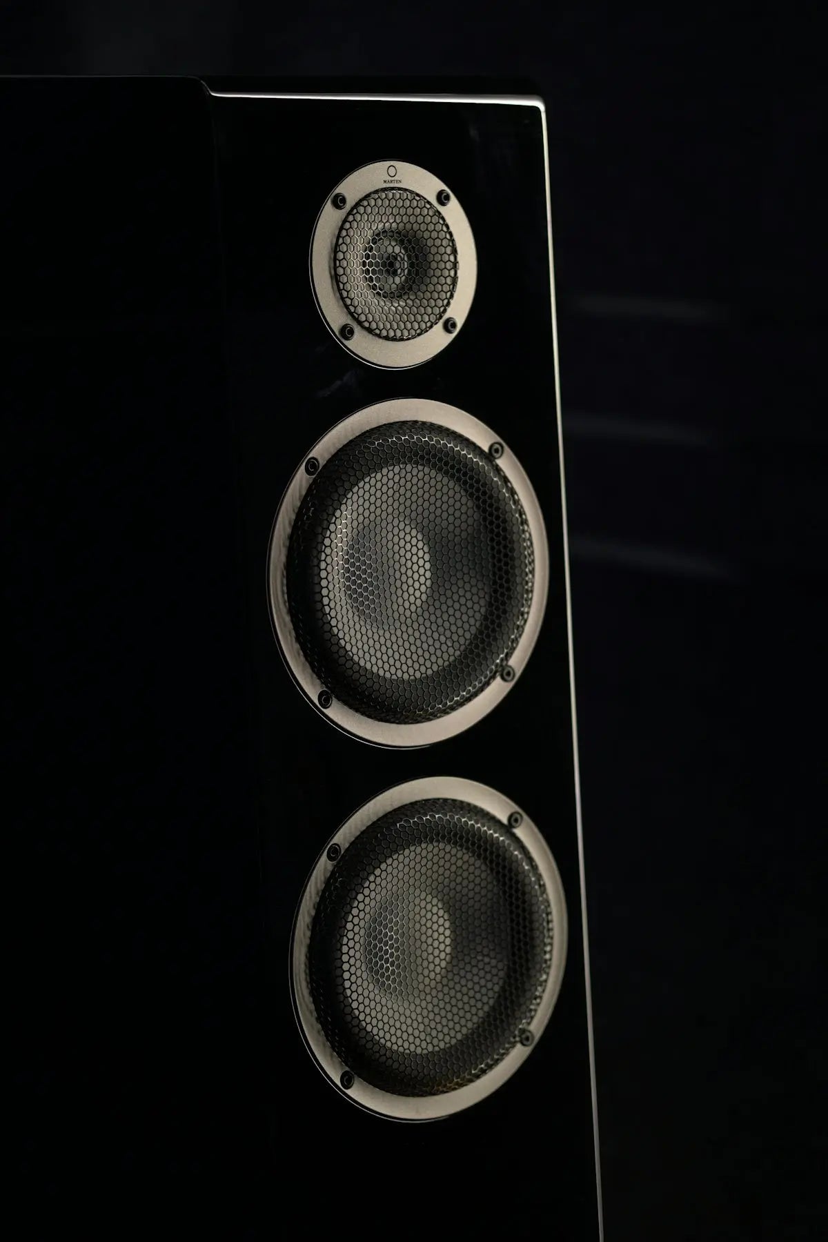 Black speaker with three drivers on-display drivers