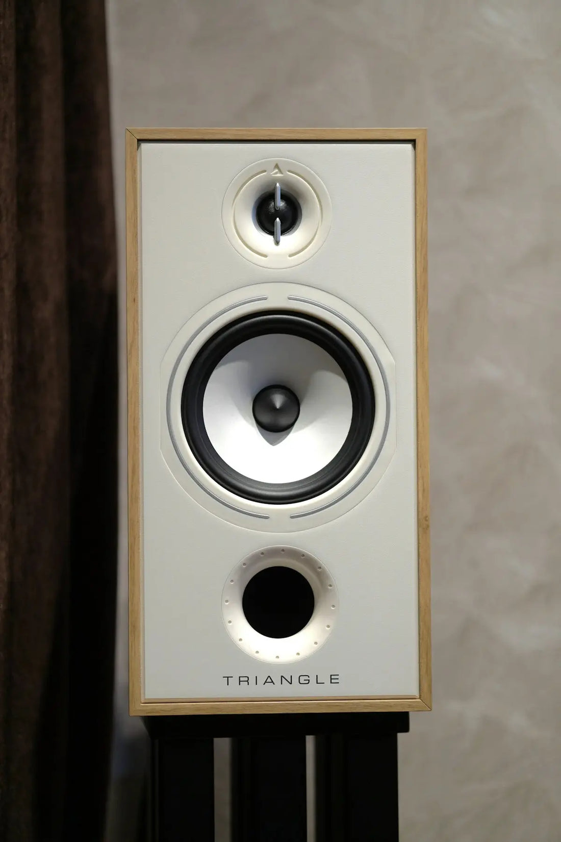 White speaker with wooden frame on stand