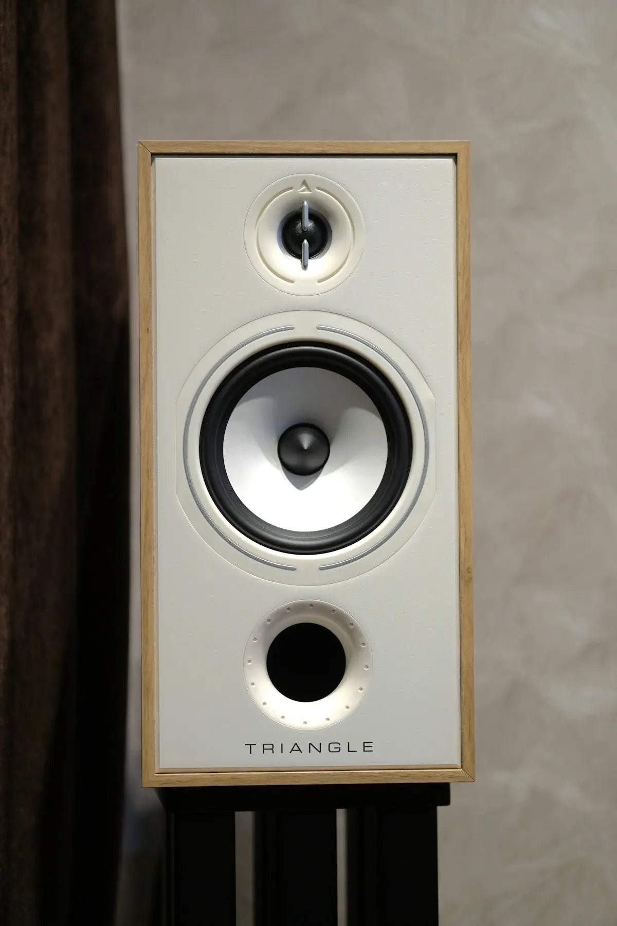 White speaker with wooden frame on stand